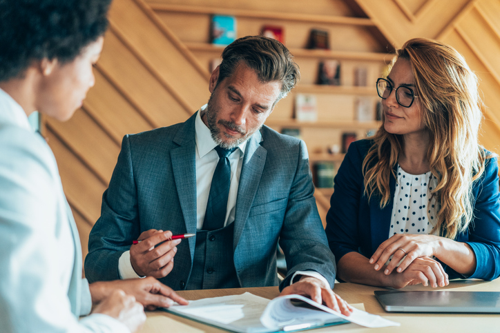 Clients reviewing a cross-border tax plan with a financial advisor.