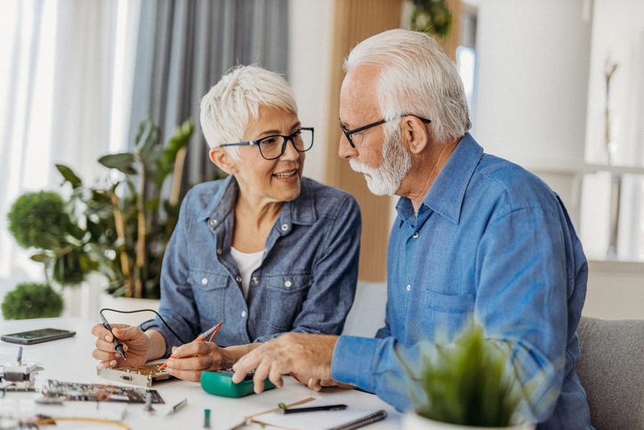 A senior couple reviews their retirement plan.